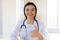 Head shot portrait smiling female doctor showing thumb up Royalty Free Stock Photo