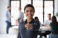 Head shot portrait smiling Indian businesswoman pointing finger at camera