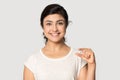 Head shot portrait smiling Indian girl showing little size gesture Royalty Free Stock Photo