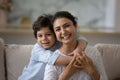 Head shot portrait smiling Indian mother and 5s son hugging