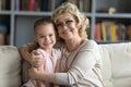 Head shot portrait smiling mature grandmother and pretty granddaughter Royalty Free Stock Photo