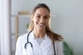 Head shot portrait smiling mixed race female doctor in uniform Royalty Free Stock Photo