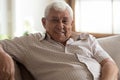 Head shot portrait smiling older man sitting on couch Royalty Free Stock Photo