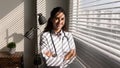 Head shot portrait smiling professional female doctor standing near window Royalty Free Stock Photo