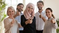 Head shot portrait of smiling multiracial group showing thumbs up. Royalty Free Stock Photo