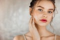 Head shot portrait smiling woman touching perfect smooth face skin