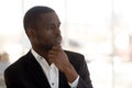 Head shot portrait thoughtful African American businessman look in distance