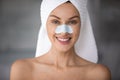 Head shot portrait woman with anti blackhead mask on nose