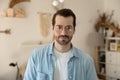 Head shot portrait of young pleasant handsome man in eyeglasses.