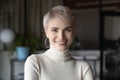 Head shot profile portrait blonde businesswoman in modern office.