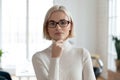 Head shot of serious business leader posing in modern office Royalty Free Stock Photo