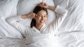 Head shot smiling beautiful woman lying in comfortable bed Royalty Free Stock Photo