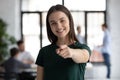 Head shot smiling businesswoman hr manager pointing finger at camera