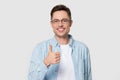 Head shot of smiling handsome man holding thumb up Royalty Free Stock Photo