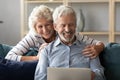 Happy elderly family couple enjoying using laptop at home. Royalty Free Stock Photo