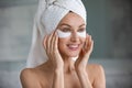 Head shot smiling woman applying hydrogel patches under eyes Royalty Free Stock Photo