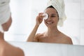 Head shot smiling woman removing face makeup, using cotton pad Royalty Free Stock Photo