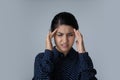 Stressed young Indian ethnicity woman suffering from headache. Royalty Free Stock Photo