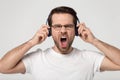 Head shot studio portrait young man enjoying favorite music. Royalty Free Stock Photo