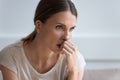 Head shot upset thoughtful young woman looking in distance