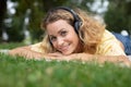 Head shot woman layed on grass listening to headphones Royalty Free Stock Photo