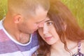 Head shot of a young affectionate romantic couple of lovers. Close up portrait of an attractive brunette girl and guy with closed Royalty Free Stock Photo