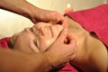 WOMAN FACIAL TEMPLE MASSAGE IN BEAUTY SPA SALON