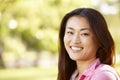 Head and shoulders portrait Asian woman outdoors Royalty Free Stock Photo