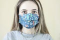 Head and shoulders portrait of female doctor wearing protective mask and looking at camera posing against white background, copy s Royalty Free Stock Photo