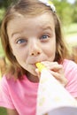 Head And Shoulders Portrait Of Girl Blowing Party Hooter