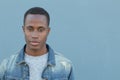 Head and shoulders portrait of a handsome African American man isolated on a blue background with copy space Royalty Free Stock Photo