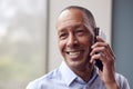 Head And Shoulders Portrait Of Mature Man Or Businessman Making Phone Call In Office Or At Home Royalty Free Stock Photo