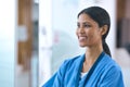 Head And Shoulders Portrait Of Smiling Female Doctor Or Nurse Wearing Scrubs In Hospital Royalty Free Stock Photo