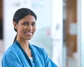 Head And Shoulders Portrait Of Smiling Female Doctor Or Nurse Wearing Scrubs In Hospital Royalty Free Stock Photo