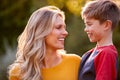 Head And Shoulders Portrait Of Smiling Mother And Son Hugging Outdoors Royalty Free Stock Photo