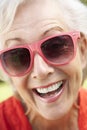 Head And Shoulders Portrait Of Smiling Senior Woman Wearing Sunglasses Royalty Free Stock Photo