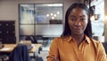 Head And Shoulders Portrait Of Smiling Young Businesswoman  Working In Modern Office Royalty Free Stock Photo