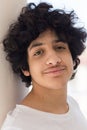 Head and shoulders portrait of a teenager boy with messy hair