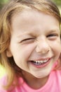 Head And Shoulders Portrait Of Winking Girl Royalty Free Stock Photo