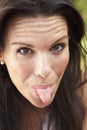 Head And Shoulders Portrait Of Woman Sticking Out Tongue Royalty Free Stock Photo