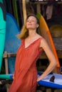 Head and shoulders portrait of young beautiful and happy blond woman smiling relaxed and cheerful posing with colorful surf boards