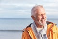 Head And Shoulders Shot Of Active Senior Man Walking Along Winter Beach With Sea Behind Royalty Free Stock Photo