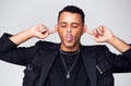 Head And Shoulders Studio Shot Of Man Pulling Faces And Smiling At Camera