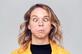 Head And Shoulders Studio Shot Of Woman Pulling Faces And Smiling At Camera