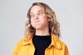 Head And Shoulders Studio Shot Of Woman Pulling Faces And Smiling At Camera