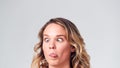 Head And Shoulders Studio Shot Of Woman Pulling Faces And Smiling At Camera Royalty Free Stock Photo