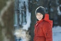 Head and shoulders winter outdoor portrait of cheerful teenage boy breathing with visible steam mouth in frosty sunny day Royalty Free Stock Photo