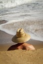 Head and shuolders of Lifeguard with straw hat surveying the beach