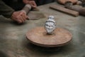 Series of head-statue handcrafted by an artisan in clay, traditional Asian, with potter hands