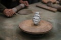 Series of head-statue handcrafted by an artisan in clay, traditional Asian, with potter hands